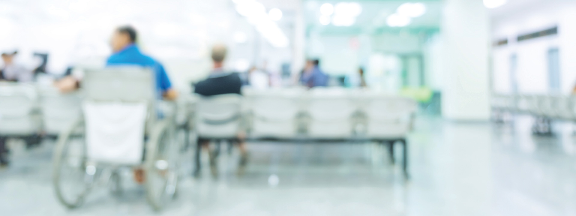 Blurred image of people in wheelchairs in a clinic